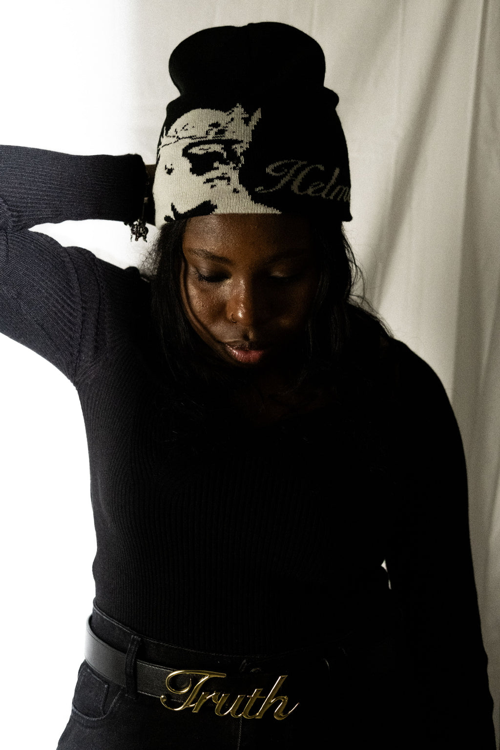 Person wearing a black helmet of salvation beanie and black belt of truth. Front. LOVE GOD BIG Christian clothing brand streetwear faith-based apparel.