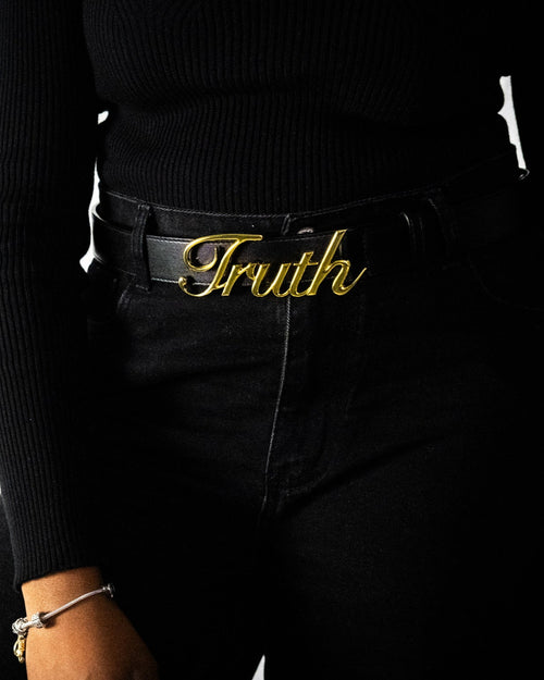 Person wearing a black outfit with a gold 'Truth' belt buckle on a white background. Front. LOVE GOD BIG. CHRISTIAN Clothing brand in New Zealand. Christian streetwear.