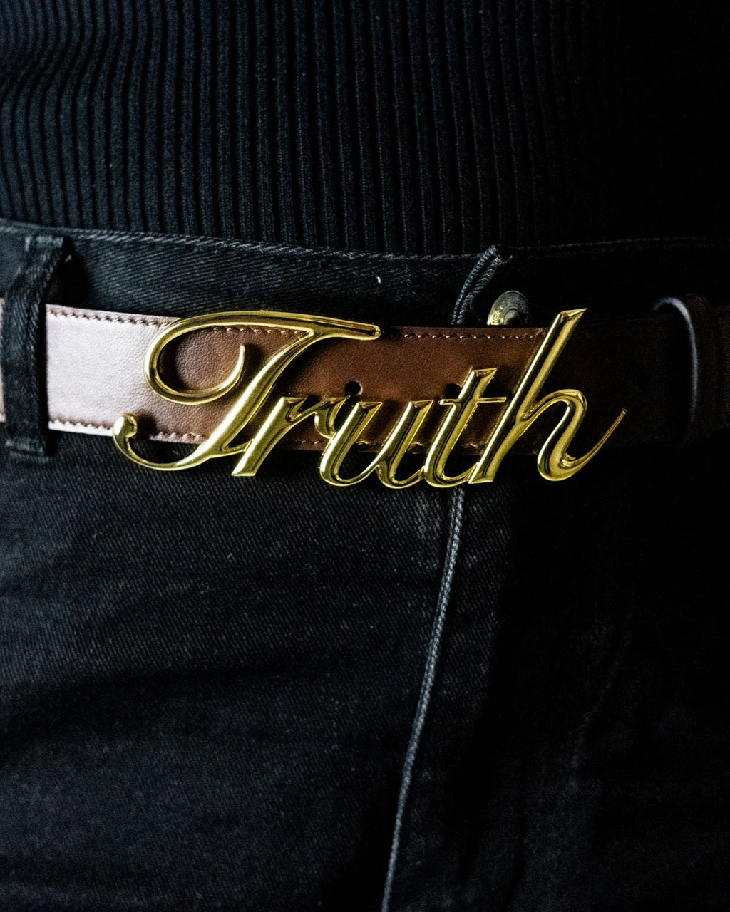 Person wearing a Gold belt buckle with 'Belt of Truth'. LOVE GOD BIG Christian clothing brand christian streetwear.