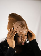 Person wearing a brown helmet of salvation beanie. LOVE GOD BIG Christian clothing brand streetwear faith-based apparel.