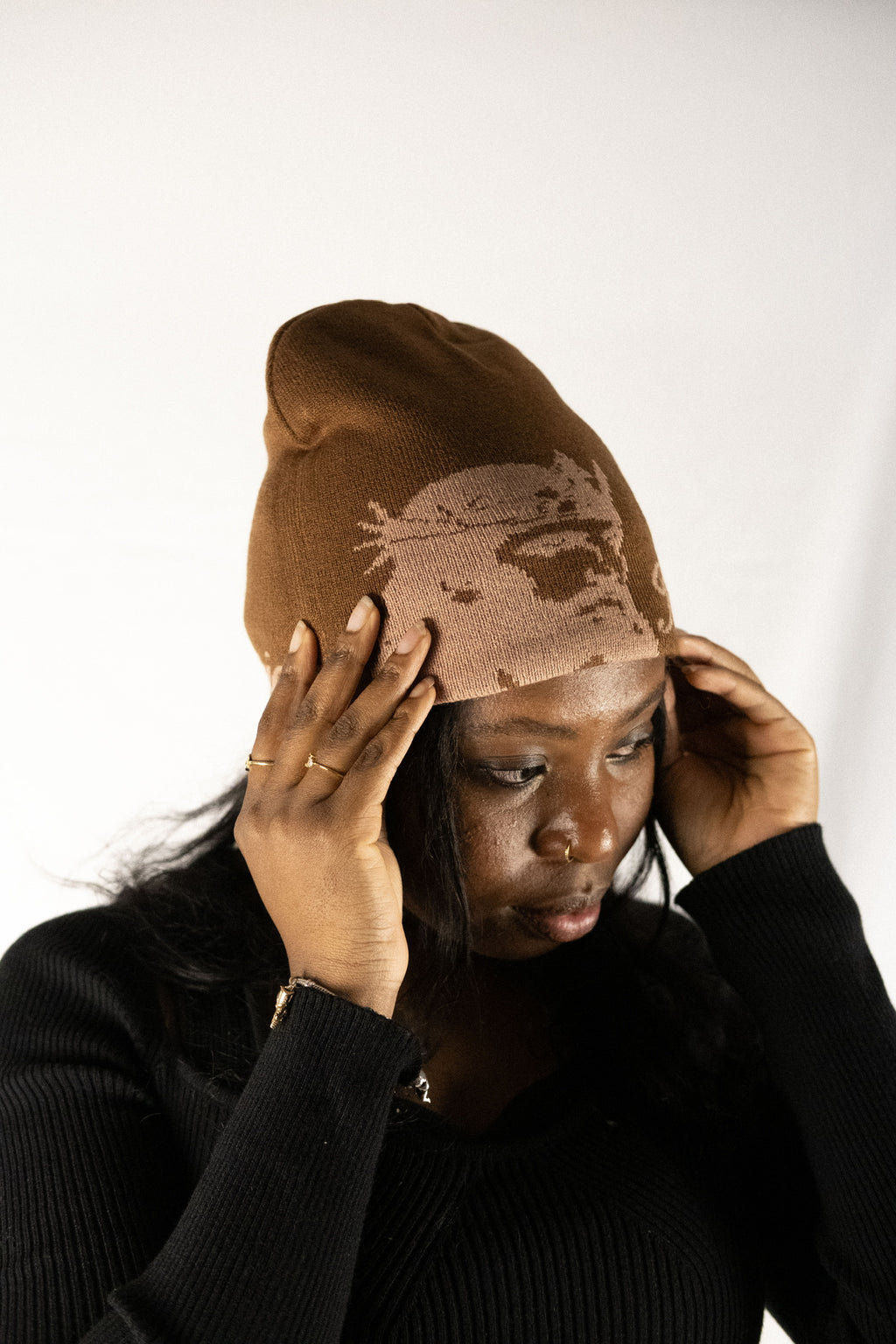 Person wearing a brown helmet of salvation beanie. Front. Close-up. LOVE GOD BIG Christian clothing brand streetwear faith-based apparel.