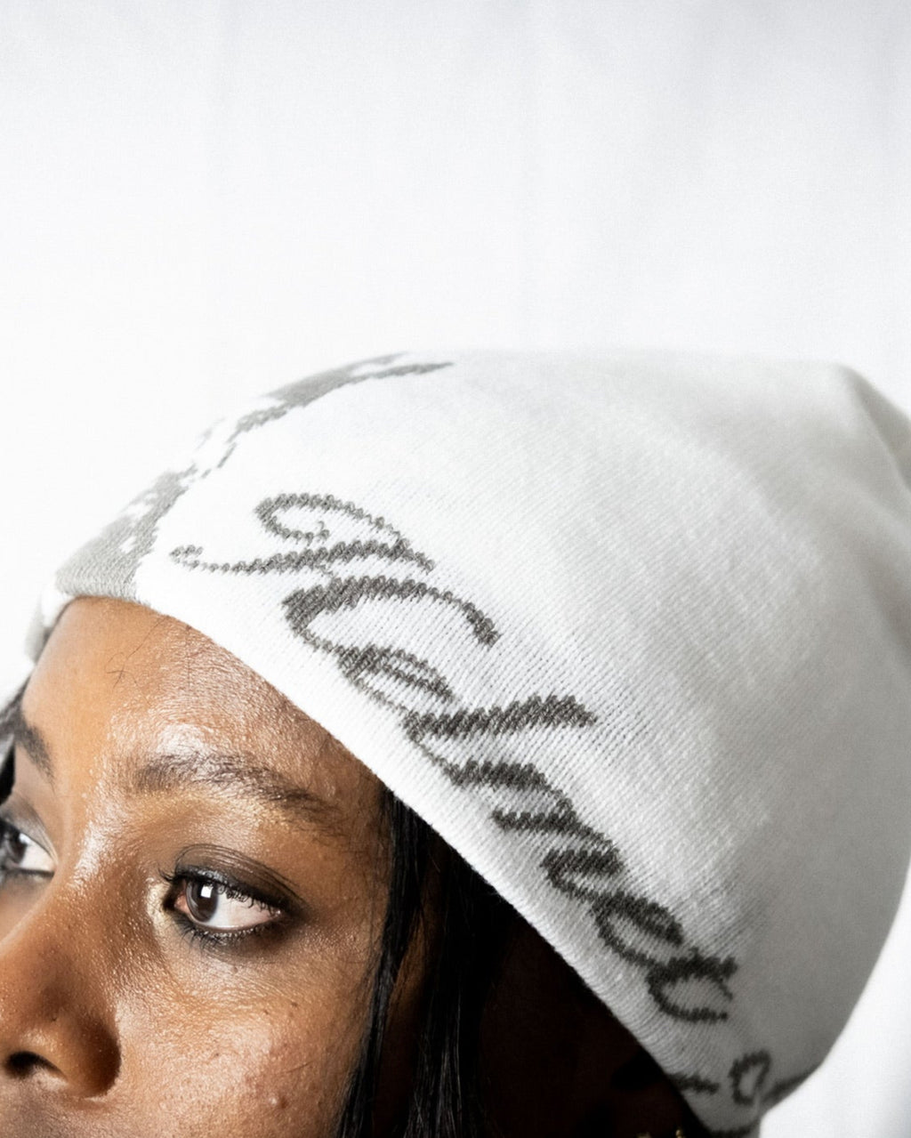 Person wearing a white helmet of salvation beanie. Side. Close-up. LOVE GOD BIG Christian clothing brand streetwear faith-based apparel.