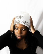 Person wearing a white helmet of salvation beanie. Front. Close-up. LOVE GOD BIG Christian clothing brand streetwear faith-based apparel.