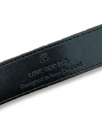 Black leather strap with 'LOVE GOD BIG' branding and text on a white background. LOVE GOD BIG Christian streetwear clothing brand. New Zealand Faith-based apparel.