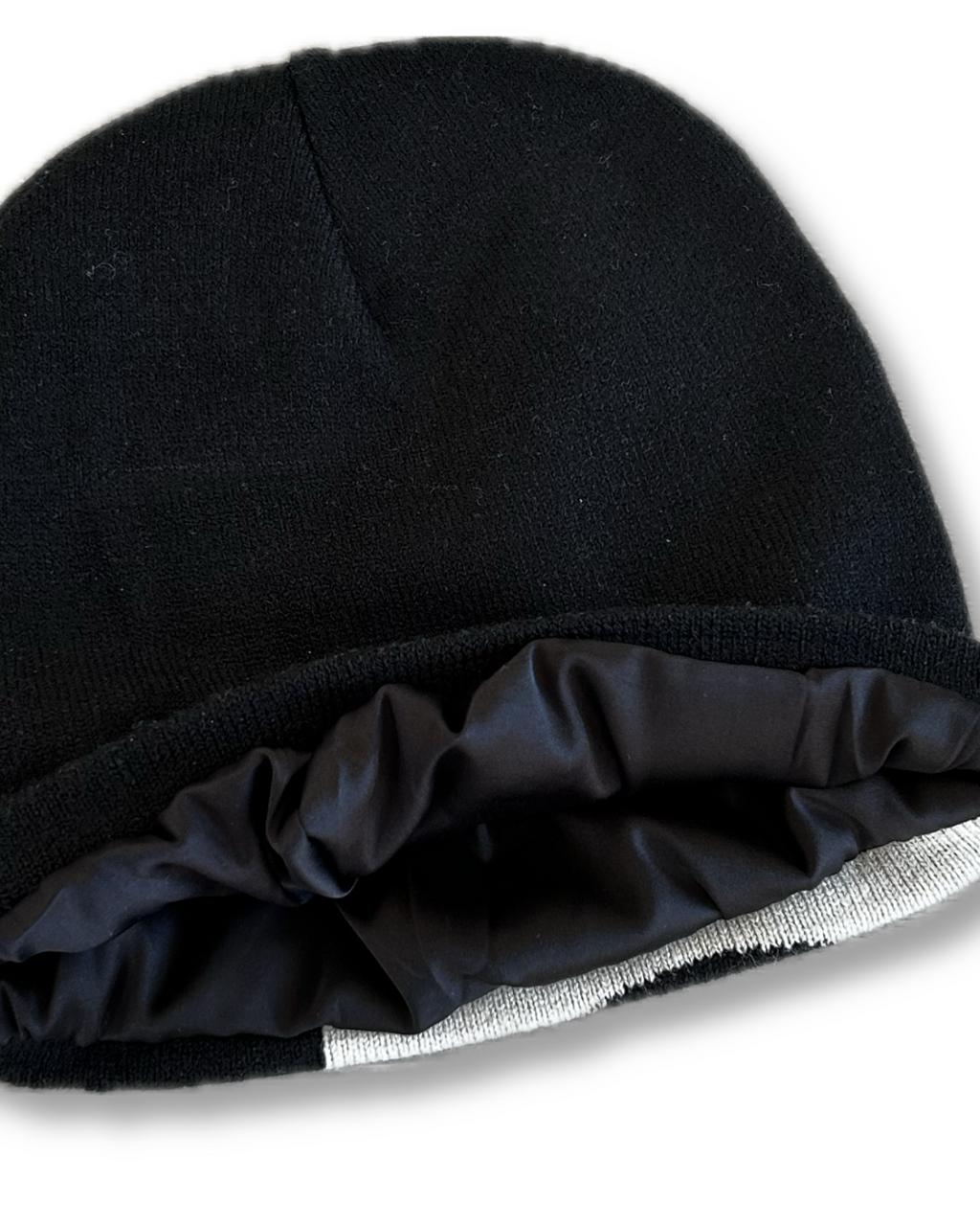 Close-up of a satin inner lining of black helmet of salvation beanie. LOVE GOD BIG Christian clothing brand streetwear faith-based apparel. 