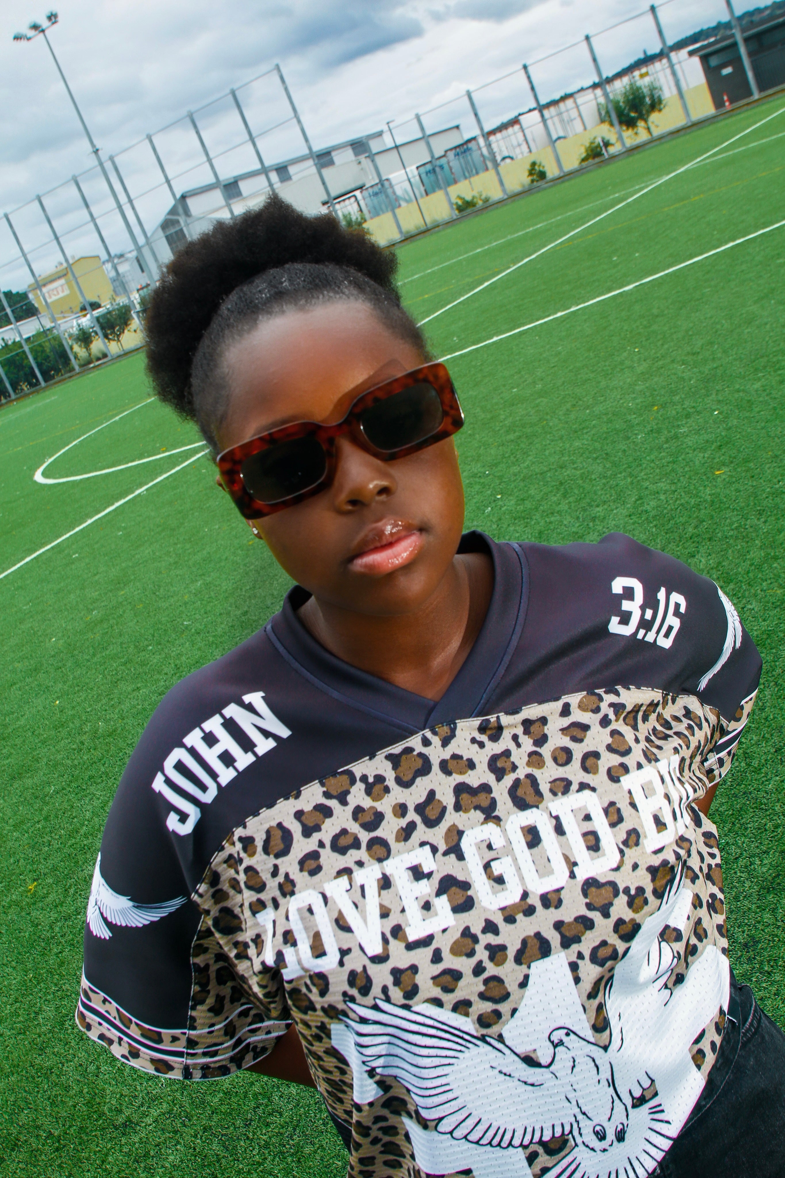 Model wearing Saviour Football Jersey in Black from LOVE GOD BIG. Front. Designed in New Zealand.